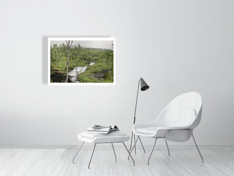 Norwegian river print on white wall in living room, mountains in background.