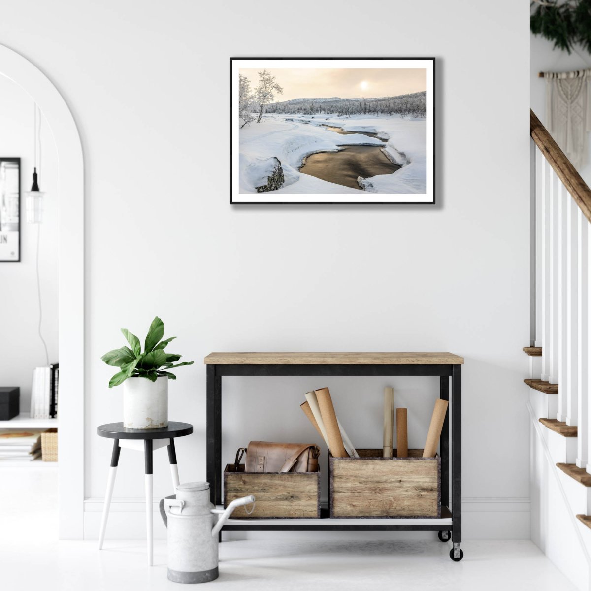 Fine art print of Arctic landscape, frozen river, bronze sunlight, on white wall above desk.