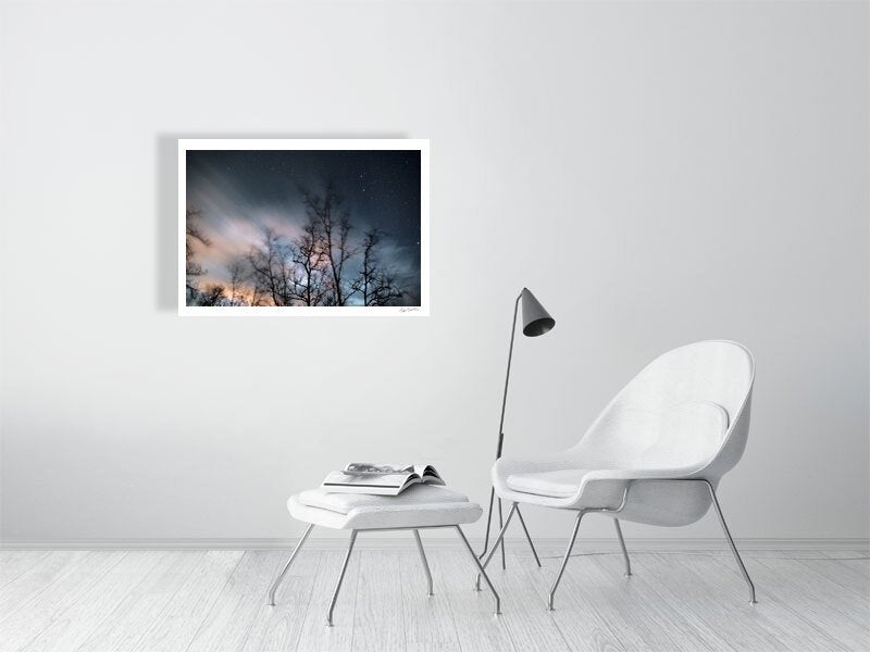 Winter storm long exposure photo print of swaying trees, rushing clouds, and fixed stars, white living room wall.