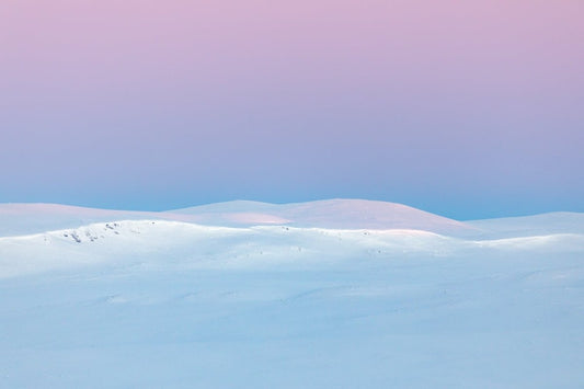Landscape photograph after the polar night, the sun rises and paints the Arctic highlands with pastel hues.