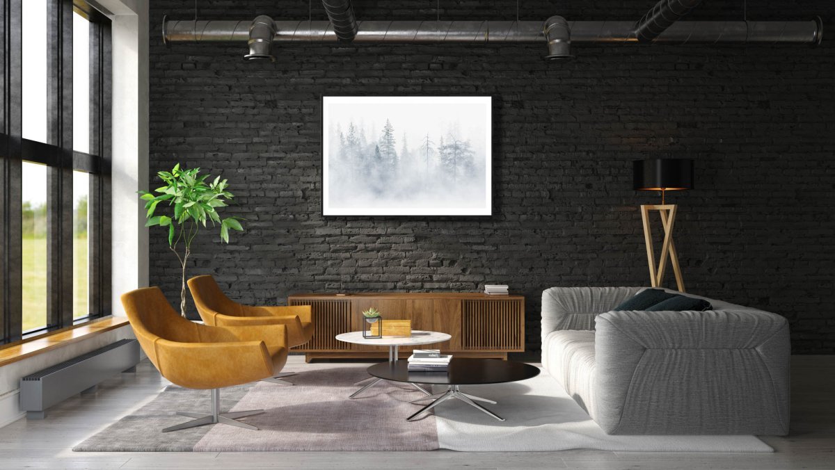 Framed photo, mist rising from lake veils northern forest, tree silhouettes, black brick wall above cabinet.