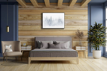 Framed photo, mist rising from lake veils northern forest, tree silhouettes, wooden wall above bed.