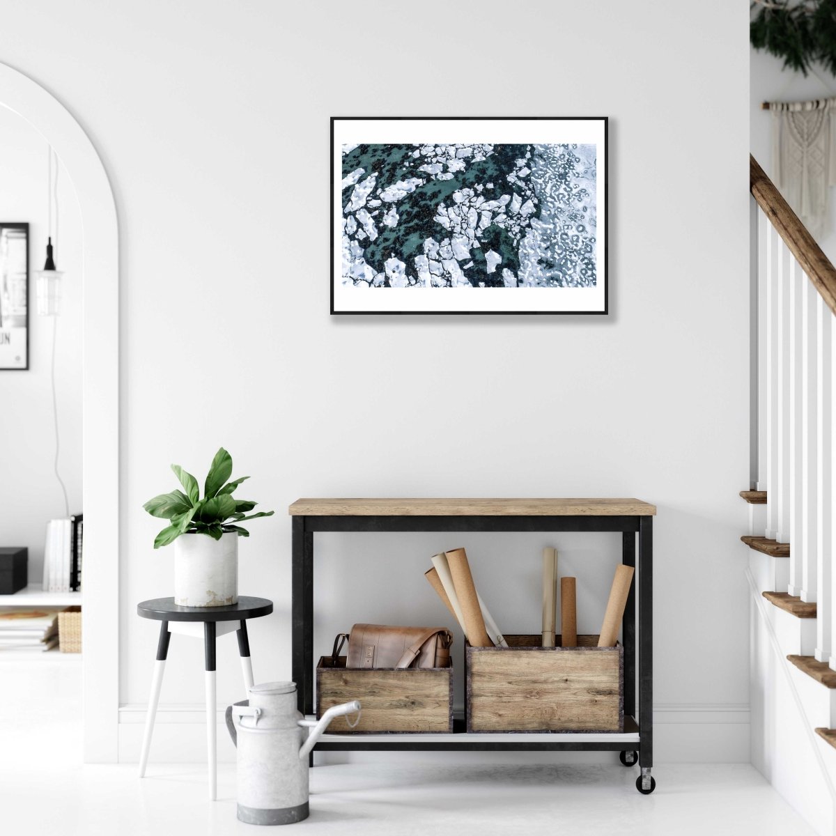 Framed aerial photo, Norwegian Sea, seabed visible between shards of ice, white living room wall.