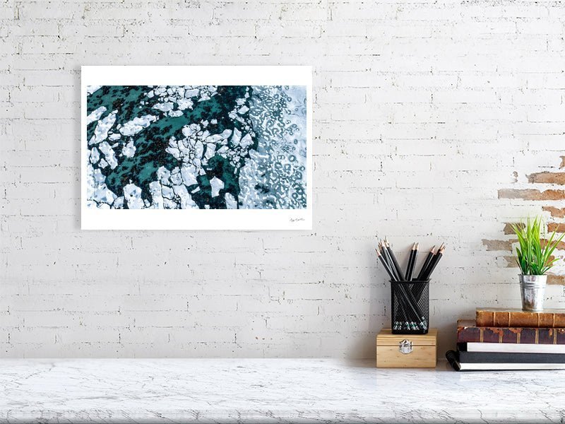 Aerial photo print, Norwegian Sea, seabed visible between shards of ice, white living room wall.