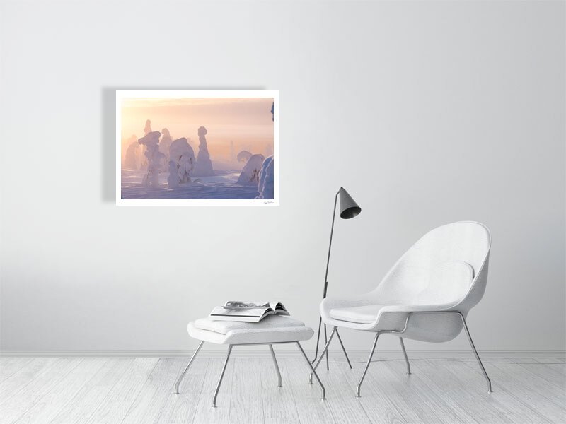 Photo print of snowy trees on misty fell, sun shining through fog, white living room wall.