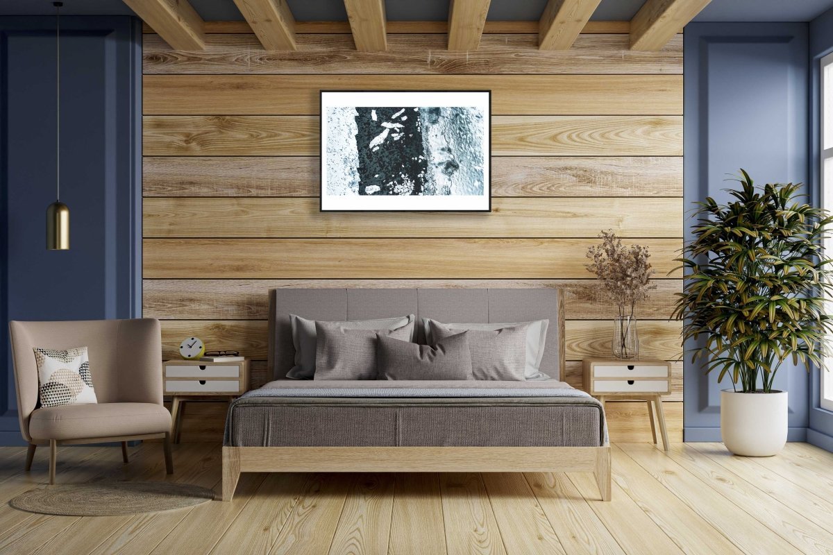 Framed aerial photo of icy Norwegian fjord with shattered ice floes, wooden bedroom wall.