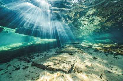 Sunlight shining through the water, illuminating the underwater steps.