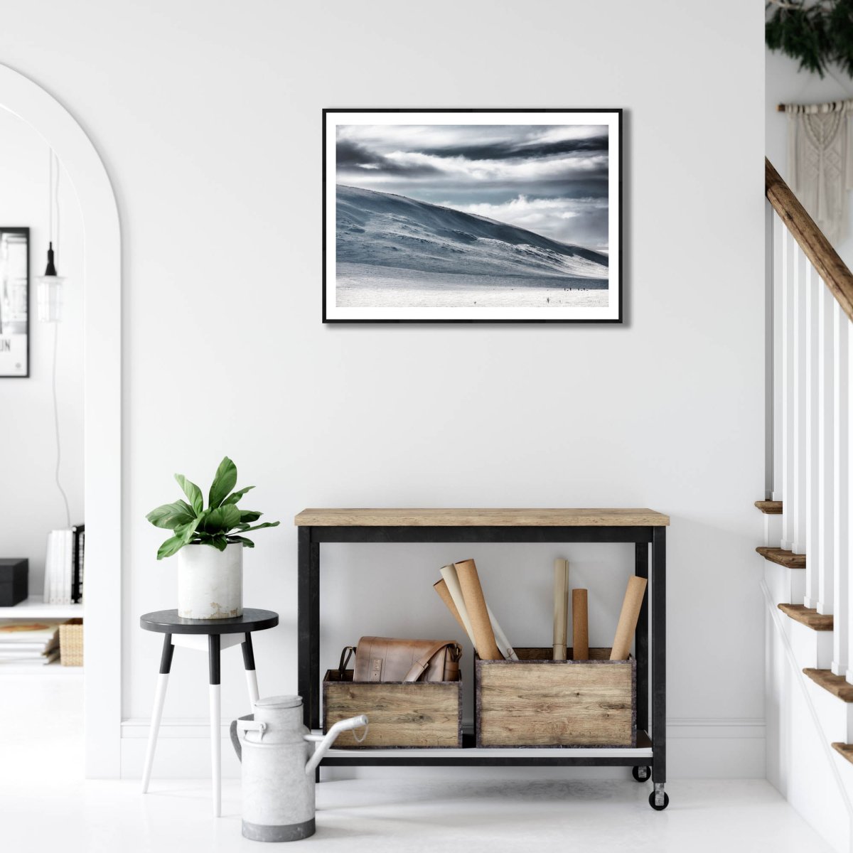 Framed photo of ski hikers in Arctic wilderness, white wall.