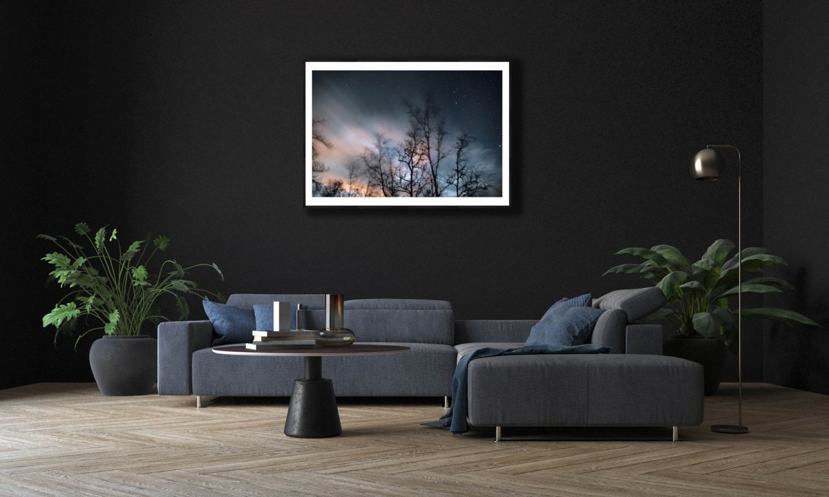 Framed winter storm long exposure photo of swaying trees, rushing clouds, and fixed stars, black bedroom wall.