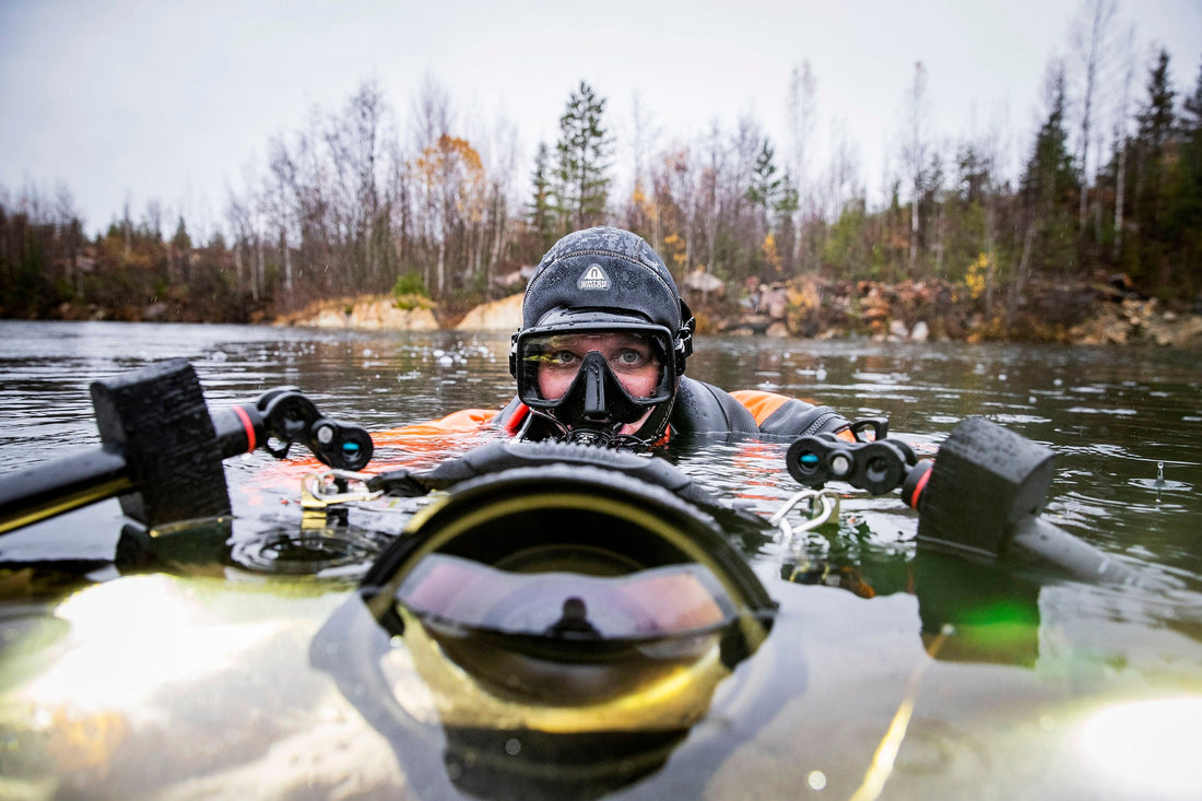 Diver looking at camera on surface with underwater camera. 