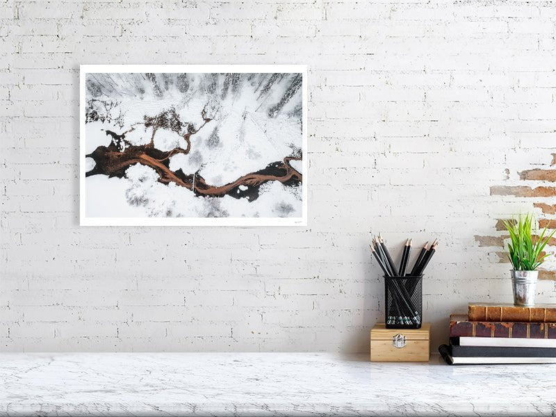 Photo print of spring streams flowing into pond in snowy forest, white living room wall.