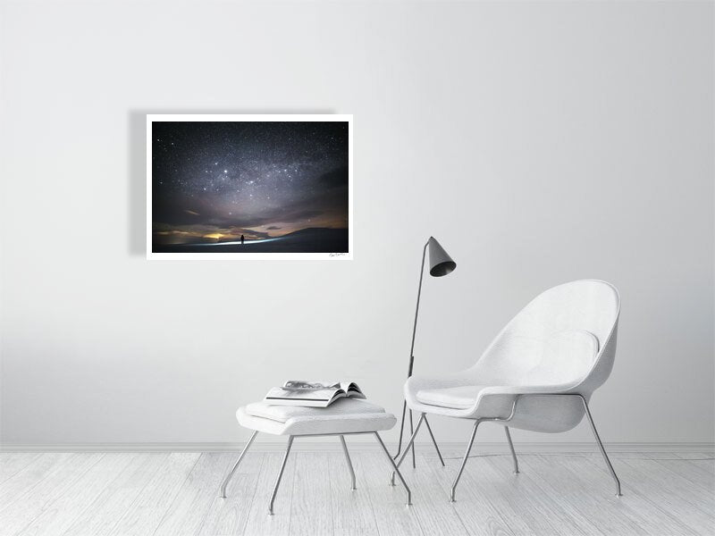 Photo print of person stargazing in the Arctic, vast night sky filled with twinkling stars, white living room wall.
