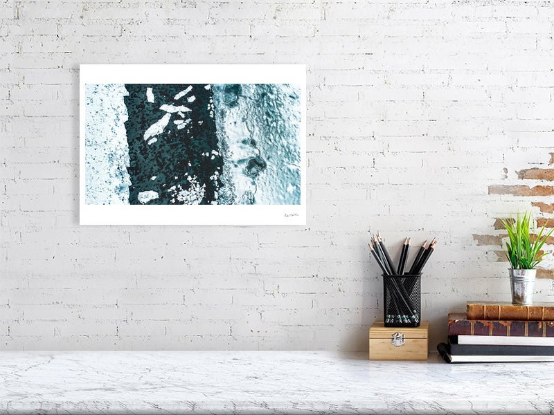 Aerial photo print of icy Norwegian fjord with shattered ice floes, white living room wall.