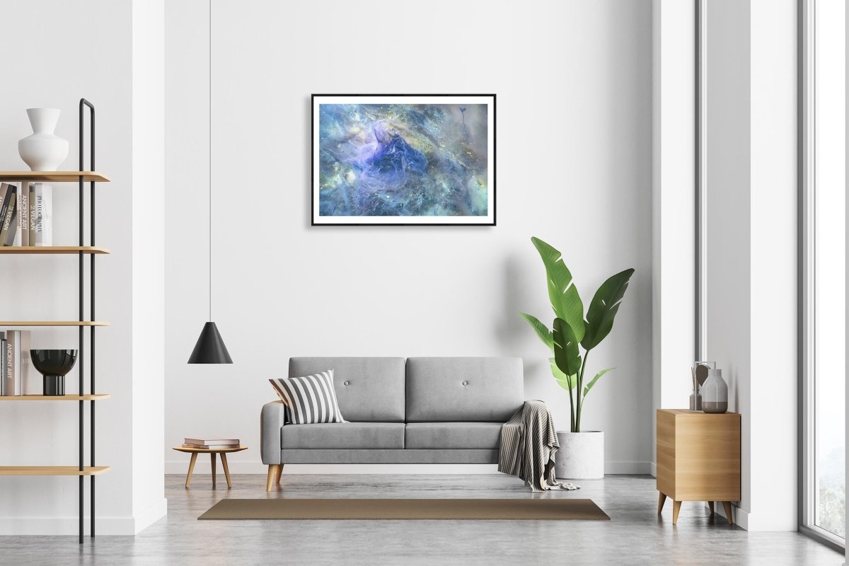 Framed print of Decaying algae lies on the bottom of a lake above a sofa in a living room.