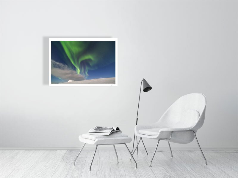 Art print of mountains, moonlight & Northern Lights on white living room wall.