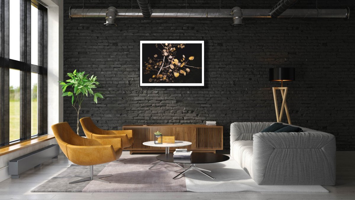 Fine art print of aspen with russet leaves, on black brick wall above cabinet.