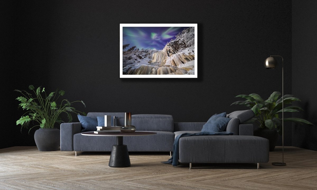 Fine art print: Northern Lights and icefall, on black wall above living room sofa.