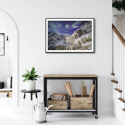 Fine art print: Northern Lights above moonlit icefall, on white wall above desk.
