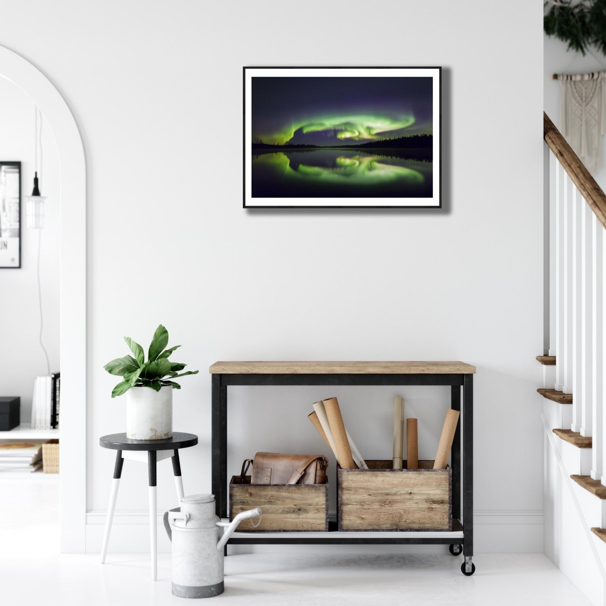 Fine art print of turtle-shaped Northern Lights reflected on a lake on white wall above desk.