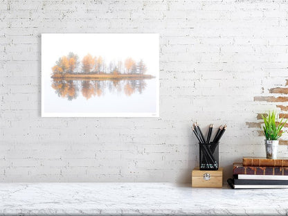 Fine art print of misty lake with autumn island on white wall.