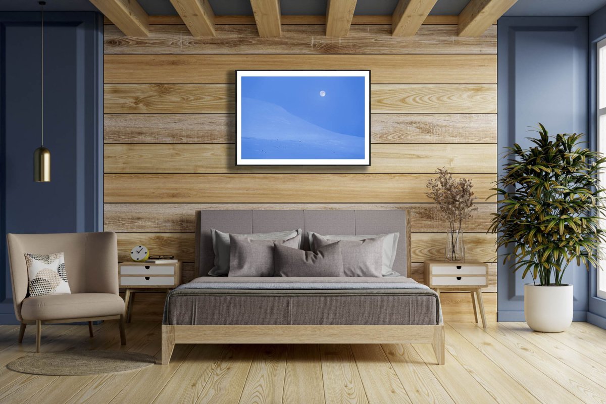 Framed Arctic landscape print, blue hour, full moon, snow-capped mountains, wooden wall.