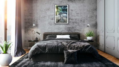 Black-framed underwater spring photo, grey stone wall, bedroom.