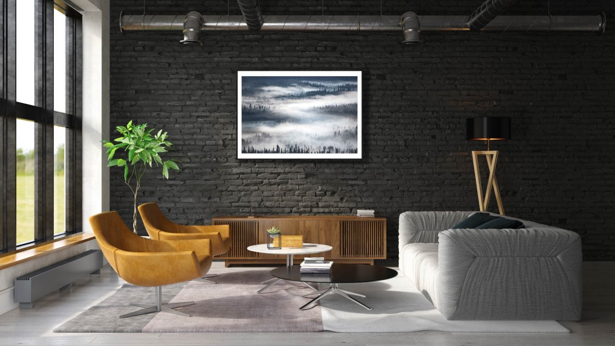 Framed foggy boreal forest photo, tree silhouettes, black brick living room wall.