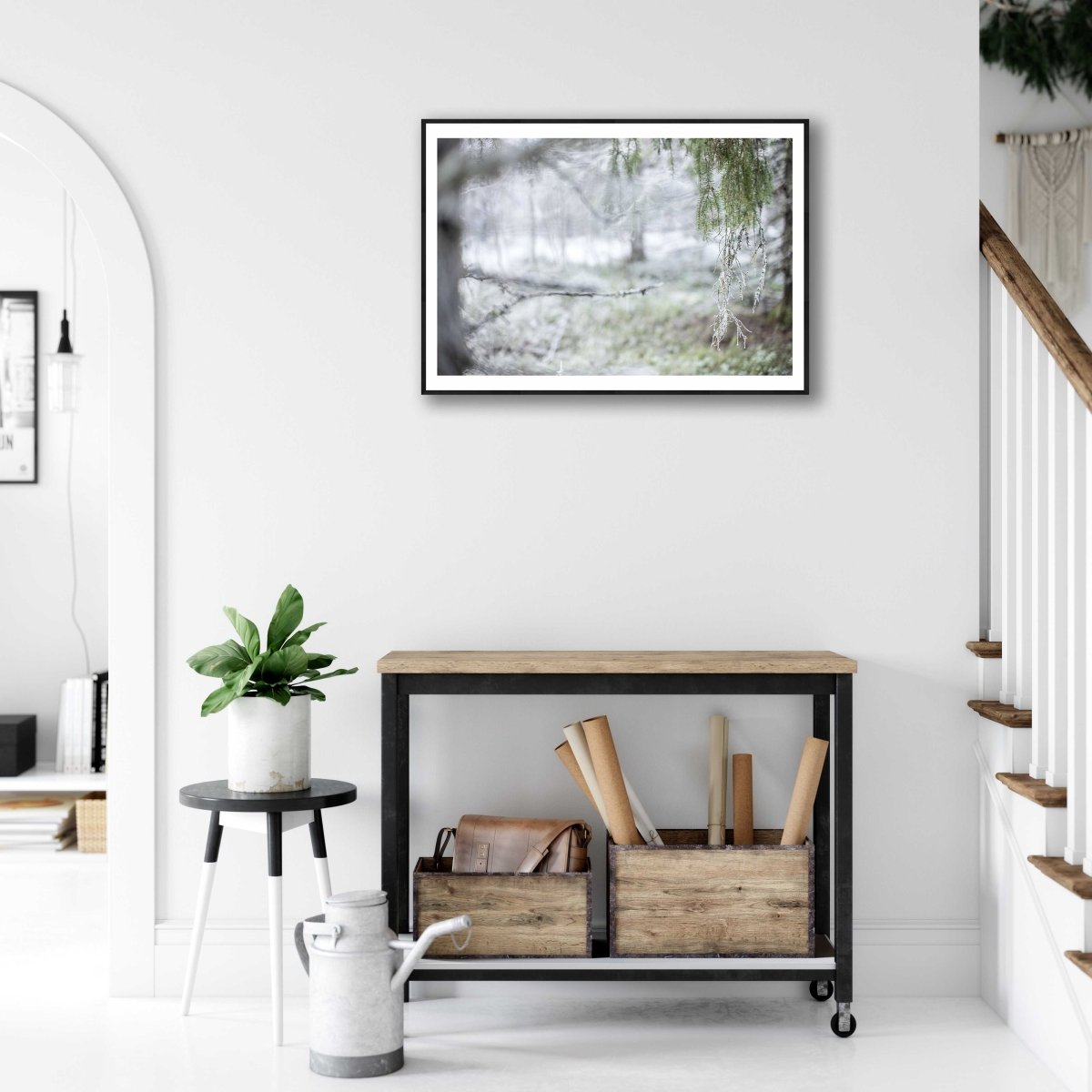 Framed print of a tilt-shift image of a frosted spruce forest in early winter on a white wall in a living room.