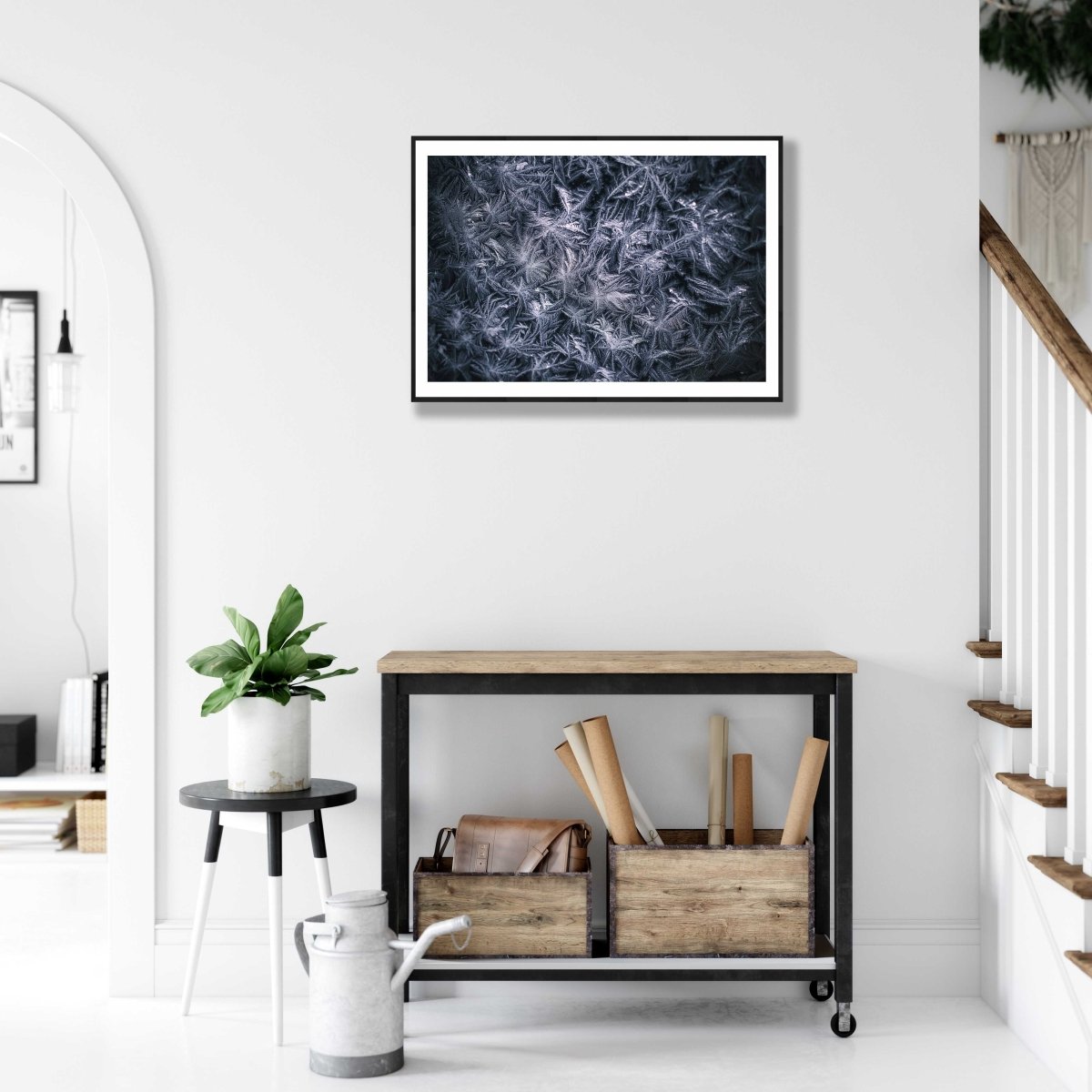 Framed close-up frost flower photo, minimalist white and deep blue palette, white living room wall.