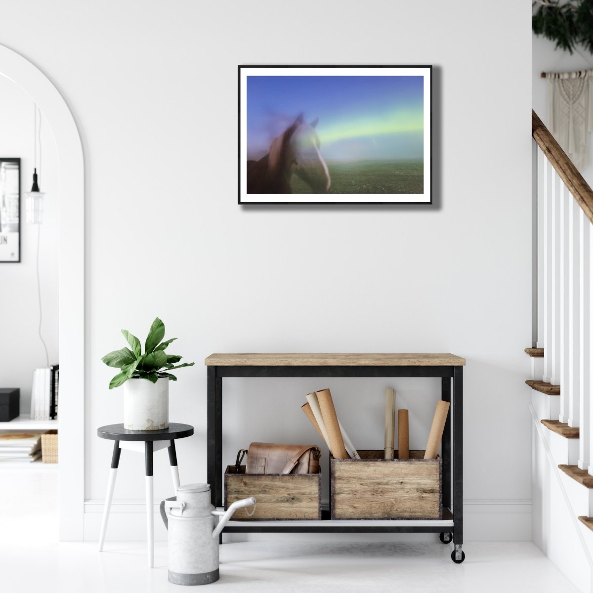 Fine art photography print of Horses with auroral antlers in a long exposure photo, black-framed, on white living room wall above desk.