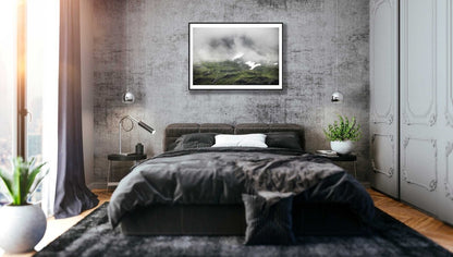 Framed photo of cloud-covered Norwegian peak with meltwater streams, snowy patches, grey wall.