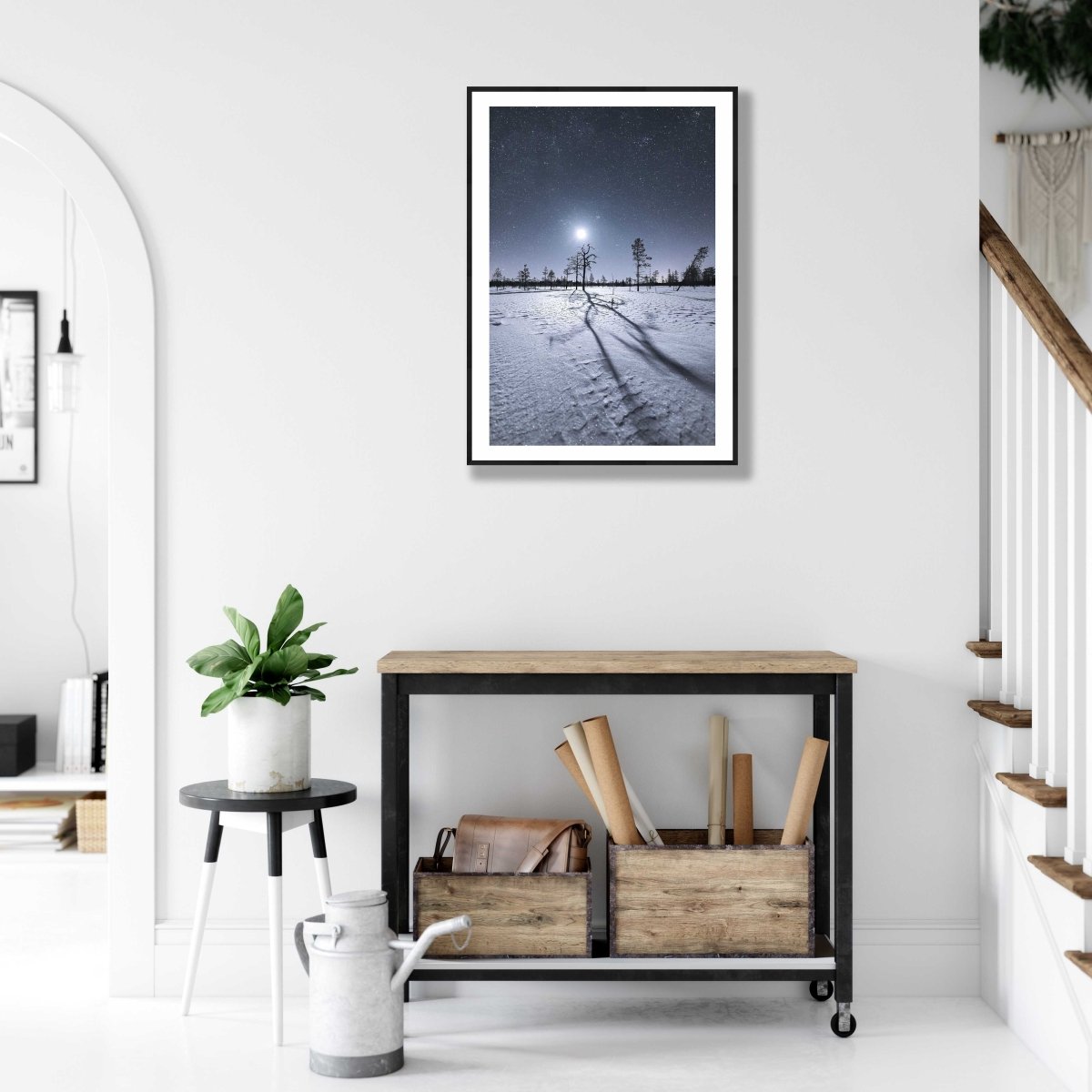 Framed photo of magical winter night in northern marshy forest, white living room wall.
