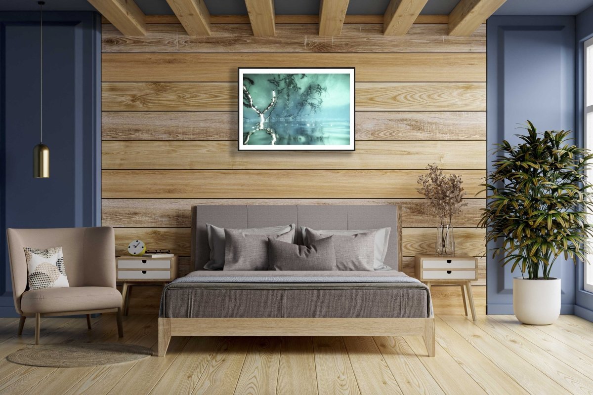 Surreal underwater branches reflecting on surface, framed on wooden bedroom wall above bed.