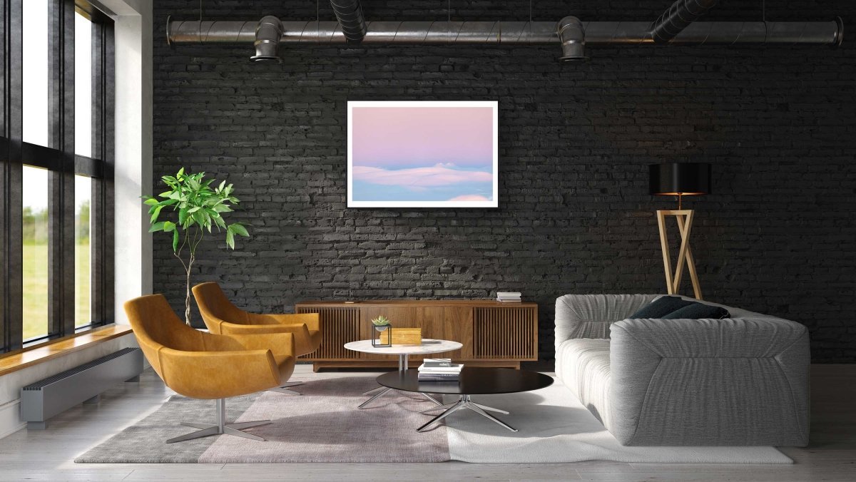 Framed photo of Arctic highland after polar night with pastel tones, black brick living room wall.