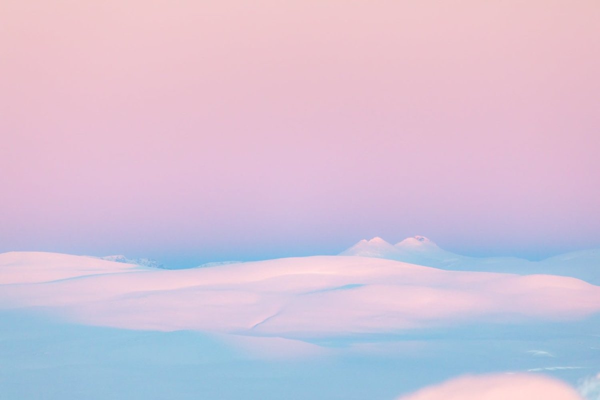 Photo of Arctic highland after polar night with pastel tones, minimalist composition, sense of cold.