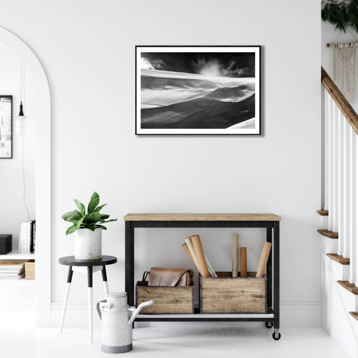 Framed black and white photo of wind-sculpted snowy ravine wall in Arctic wilderness, white living room wall.