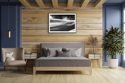 Framed black and white photo of wind-sculpted snowy ravine wall in Arctic wilderness, wooden bedroom wall.