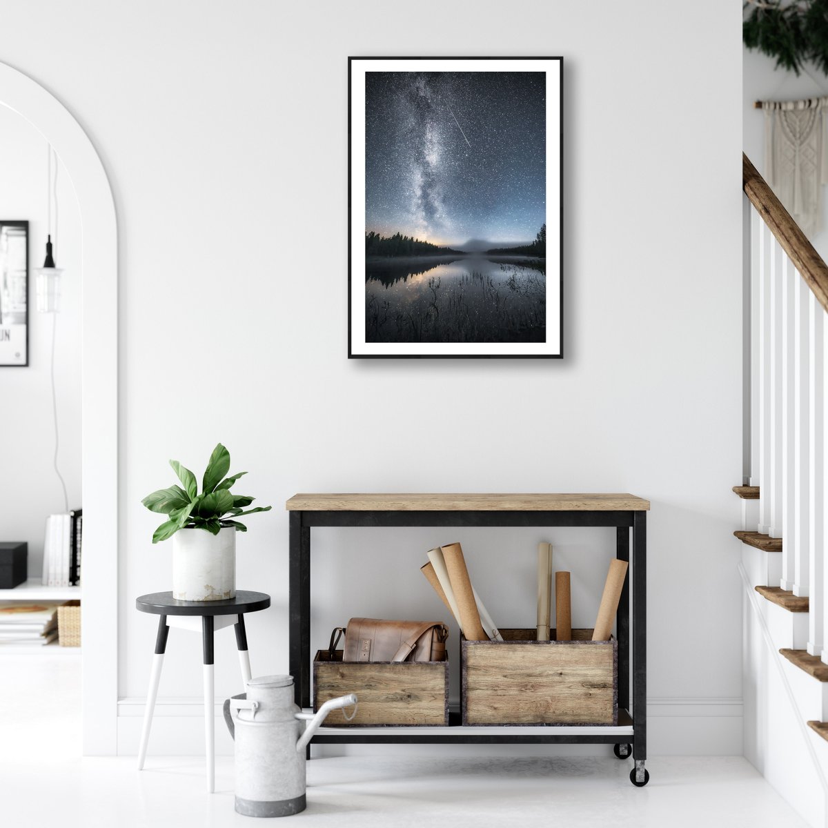 Framed photo of Milky Way, stars, and shooting star mirrored in lake, northern autumn night, white living room wall.