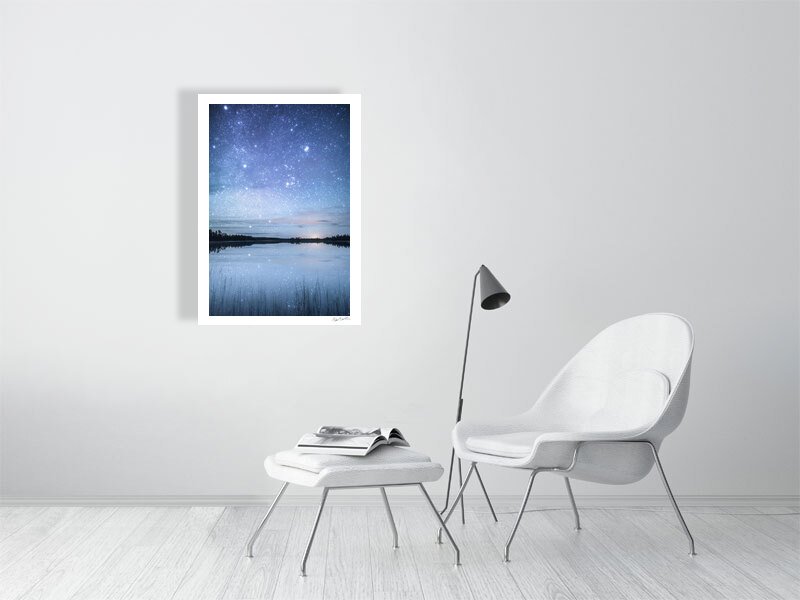 Fine art photo print of starry night reflected on tranquil lake in northern Finland, white living room wall.
