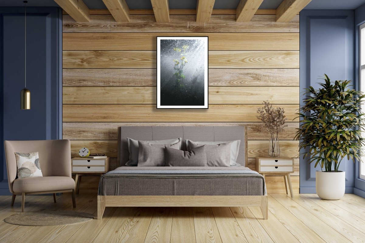 Framed water crowfoot blooms photo, wooden wall above bed in bedroom.
