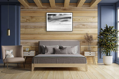 Framed black and white photo of mountain birch standing firm in frozen Arctic wilderness, wooden bedroom wall.