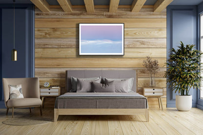 Framed photo of Arctic highlands after polar night, sun rising, pastel hues, wooden bedroom wall.